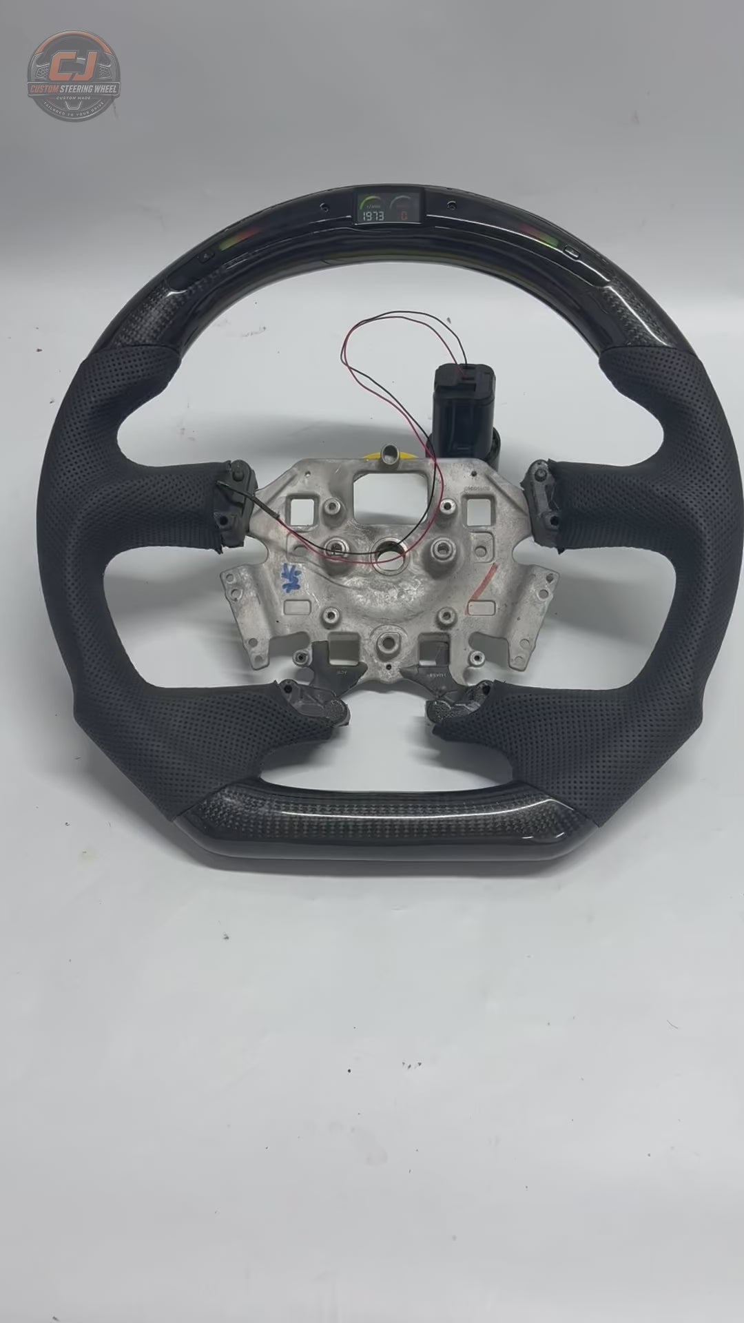 Ford Falcon FG XR XR6 XR8 LED custom steering wheel video on white background with carbon fiber and black perforated leather by CJ Mod Garage